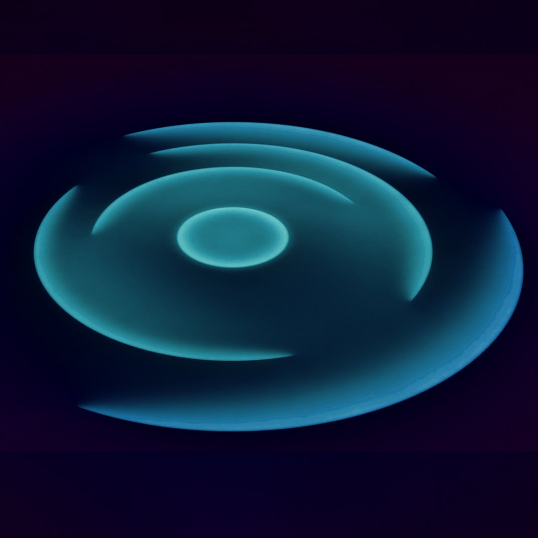 Wireless charging pad with glowing blue light, modern tech accessory.
