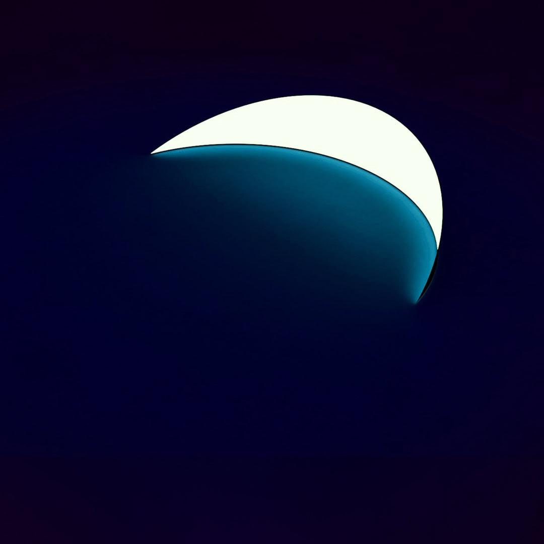 Moonlit night with a crescent moon in the dark sky.