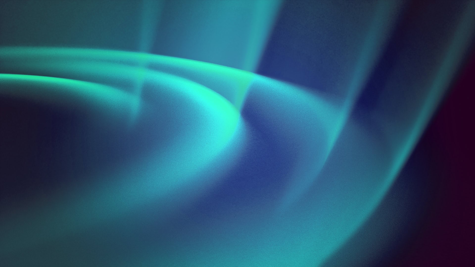 Abstract image of glowing blue and green light waves.